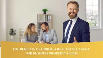 Professional real estate agent smiling and giving a thumbs-up, with a business couple discussing in the background, and text overlay reading "The Benefits of Hiring a Real Estate Agent for Business Property Needs."