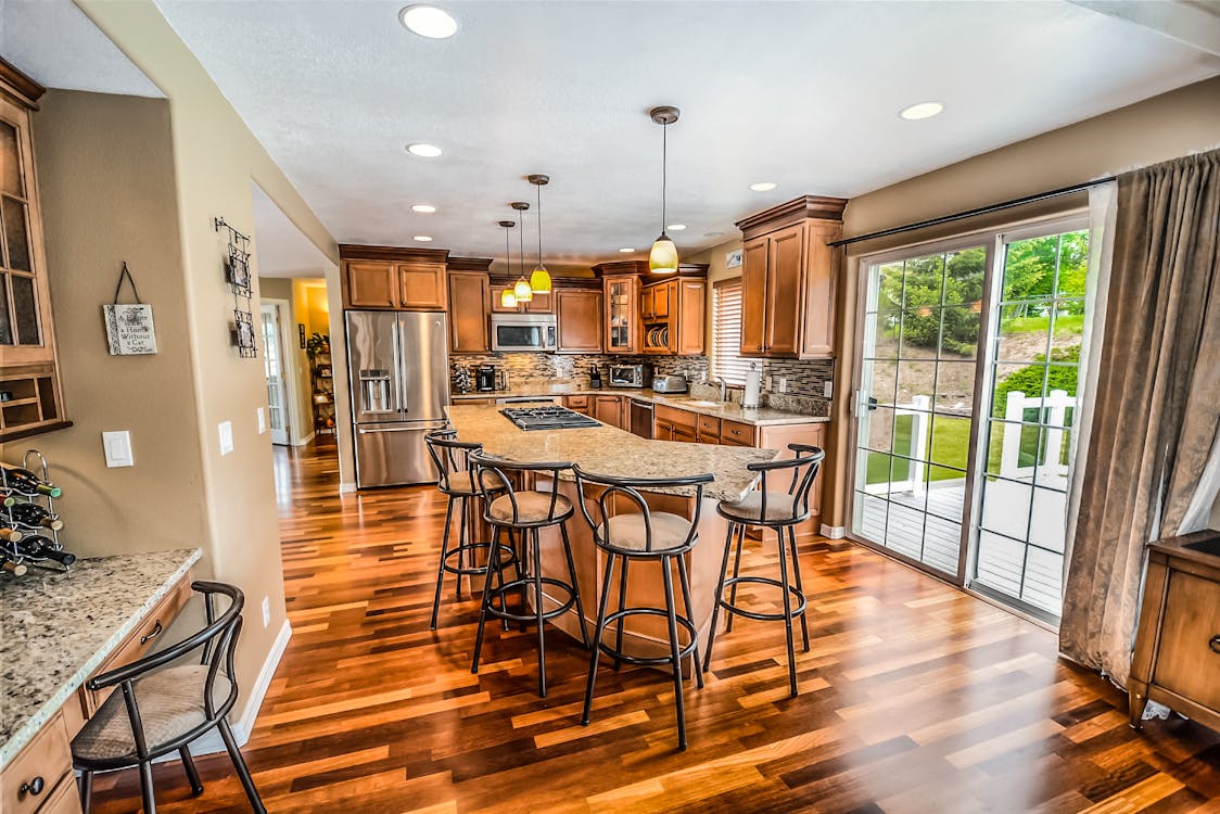 Two distinct sets of house keys lying side-by-side on a clean, modern surface, symbolizing the choice between different real estate selling options.