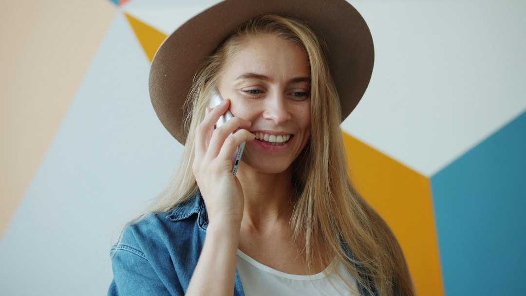 A happy and relieved home seller holding a set of house keys in a bright, modern living room, celebrating their financial savings.