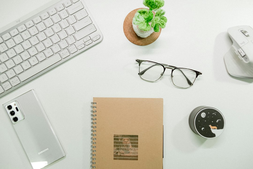 A pair of house keys resting on a sleek calculator on a clean, minimalist desk, symbolizing the financial calculations and savings involved in selling a home.